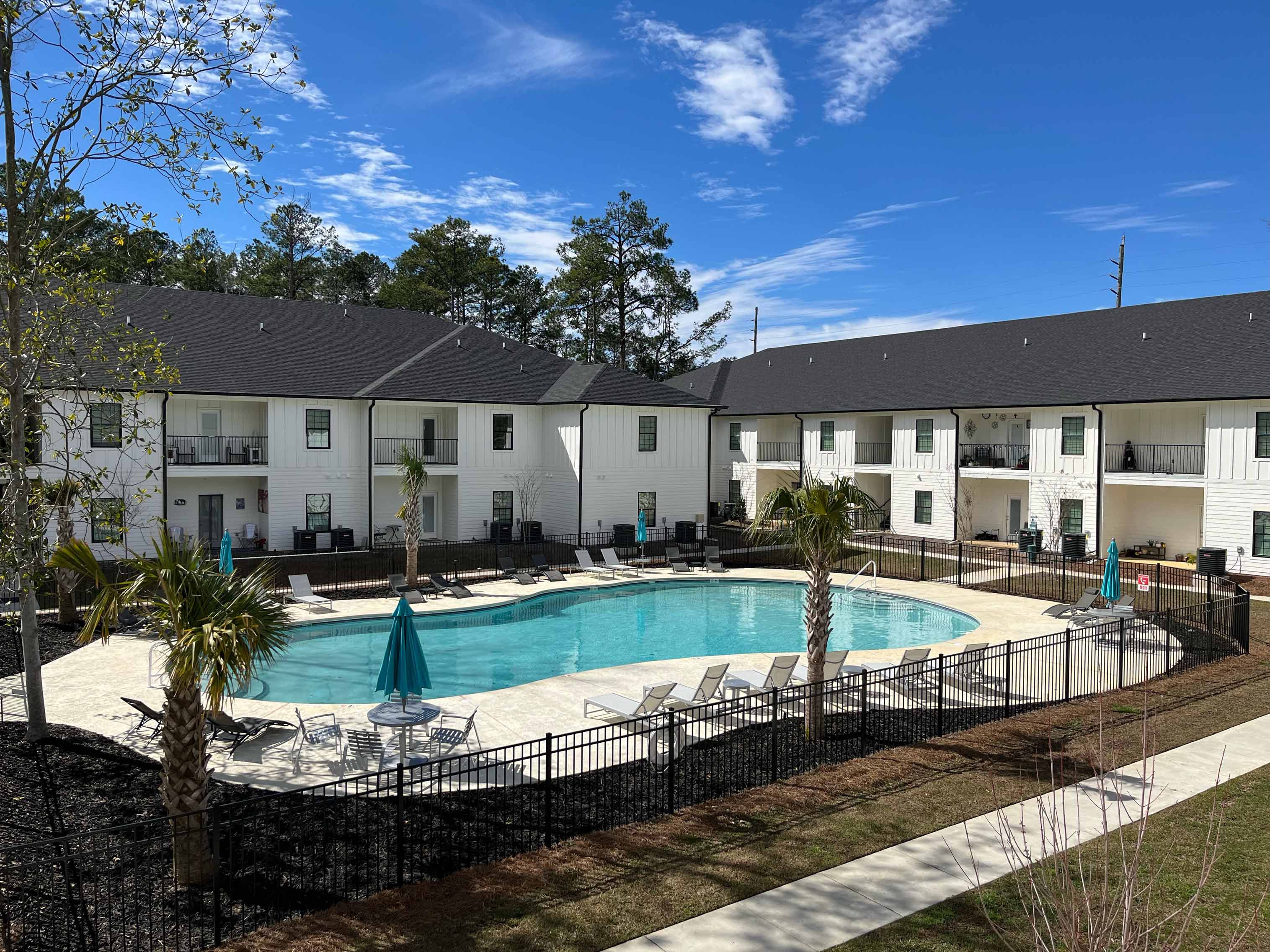 view of verandas apartments with gated pool and clubhouse