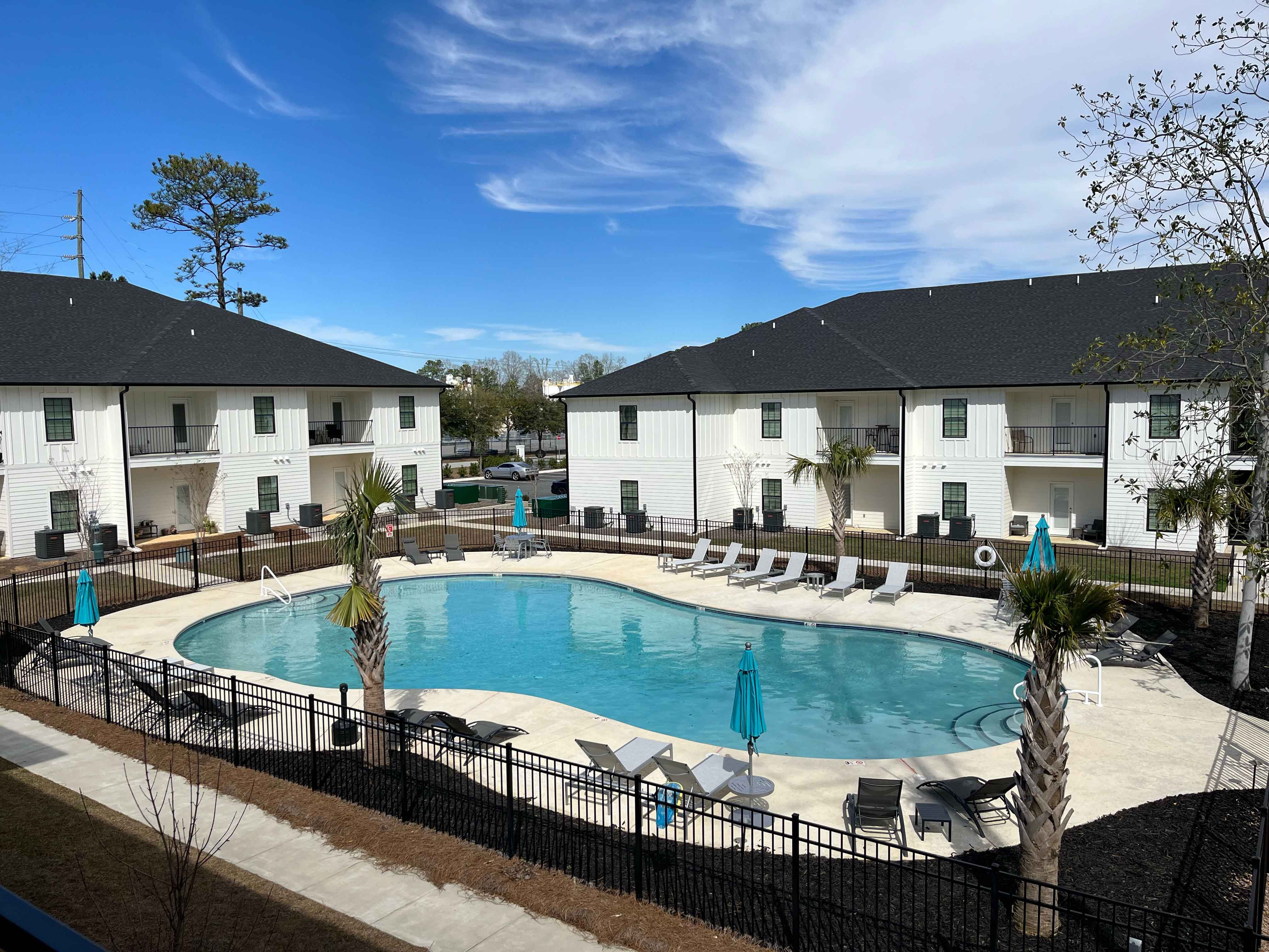 view of verandas apartments with gated pool and clubhouse