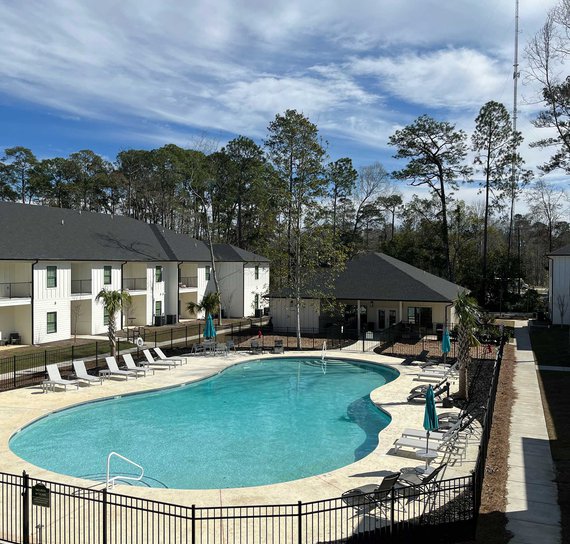 view of verandas apartments with gated pool and clubhouse